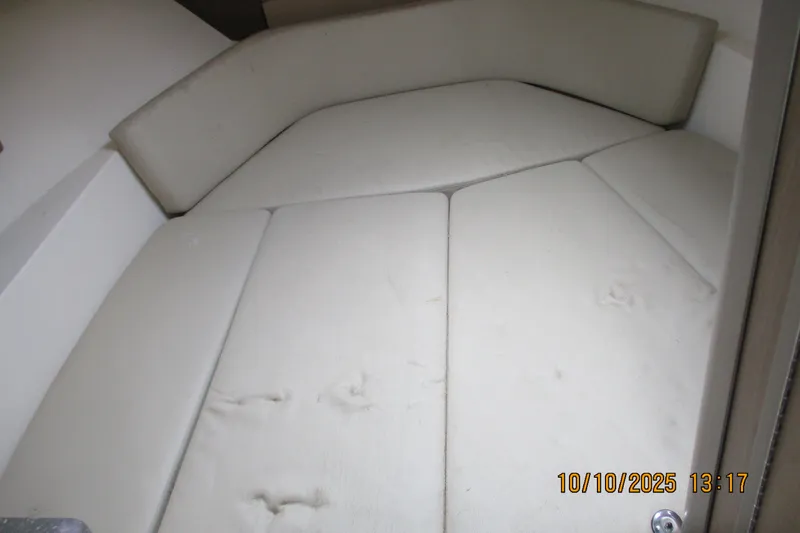 Slide: The Image of Interior cabin of 2013 Boston Whaler 315 Conquest with white cushioned seating. - 23