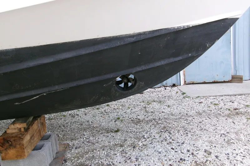 Slide: The Image of 2013 Boston Whaler 315 Conquest hull with bow thruster, on blocks. - 32