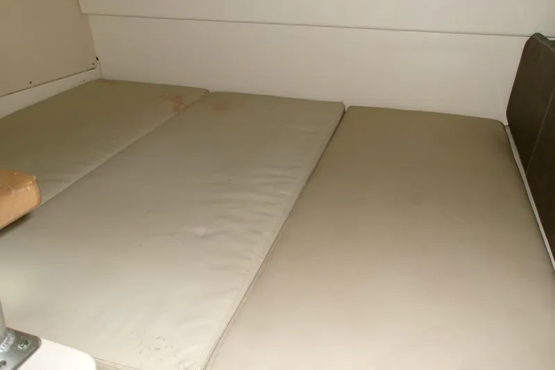 Slide: The Image of Interior cabin view of 2013 Boston Whaler 315 Conquest with beige cushions. - 39