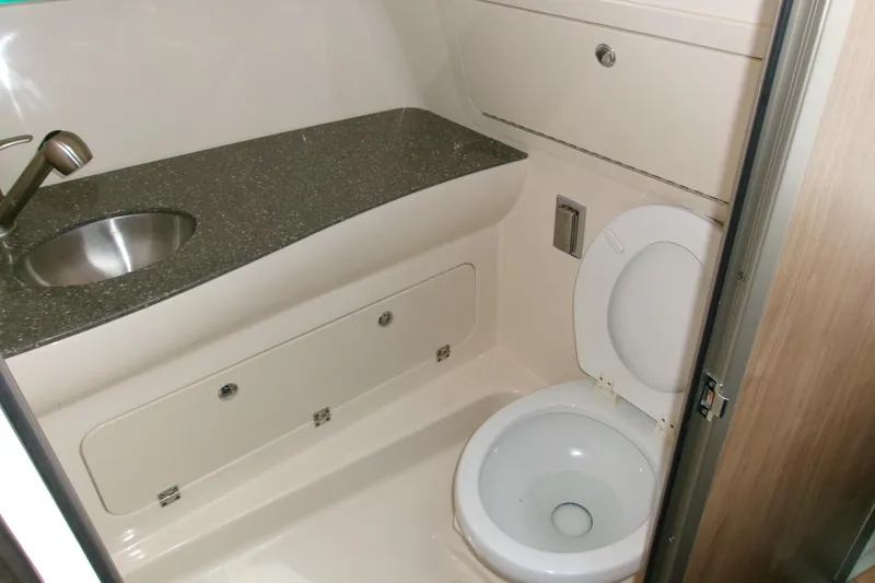 Slide: The Image of 2013 Boston Whaler 315 Conquest boat bathroom with sink and toilet. - 41