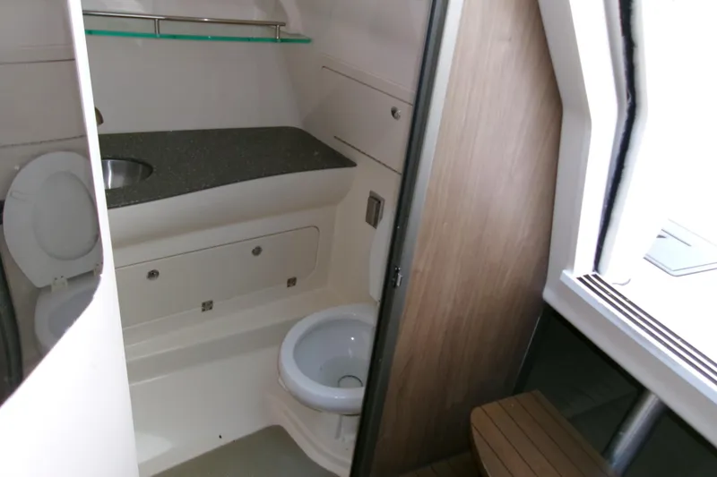 Slide: The Image of 2013 Boston Whaler 315 Conquest bathroom interior with sink and toilet. - 42
