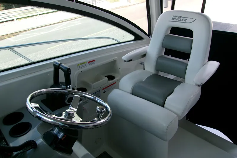 Slide: The Image of Interior helm of 2013 Boston Whaler 315 Conquest with steering wheel and captain's chair. - 44