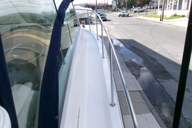 Slide: The Image of 2013 Boston Whaler 315 Conquest boat docked on a city street. - 45