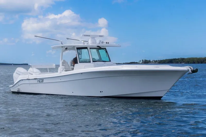 Slide: The Image of 2023 HCB 39 Speciale boat on calm water under blue sky. - 0