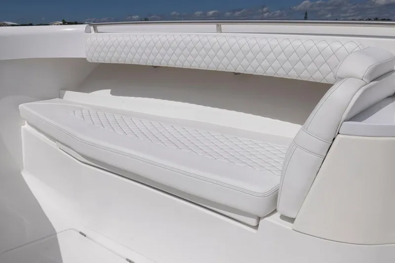Slide: The Image of Luxurious white seating on 2023 HCB 39 Speciale boat, featuring diamond-pattern upholstery. - 11