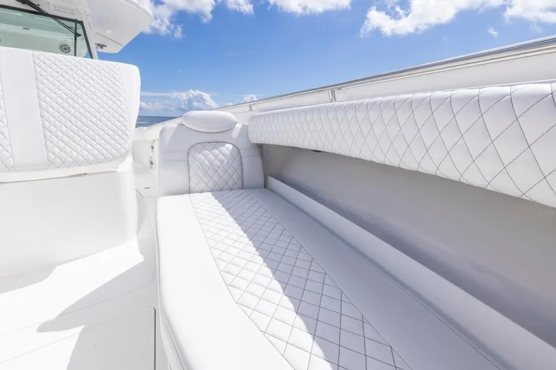 Slide: The Image of Luxurious white seating on 2023 HCB 39 Speciale boat under blue sky. - 13