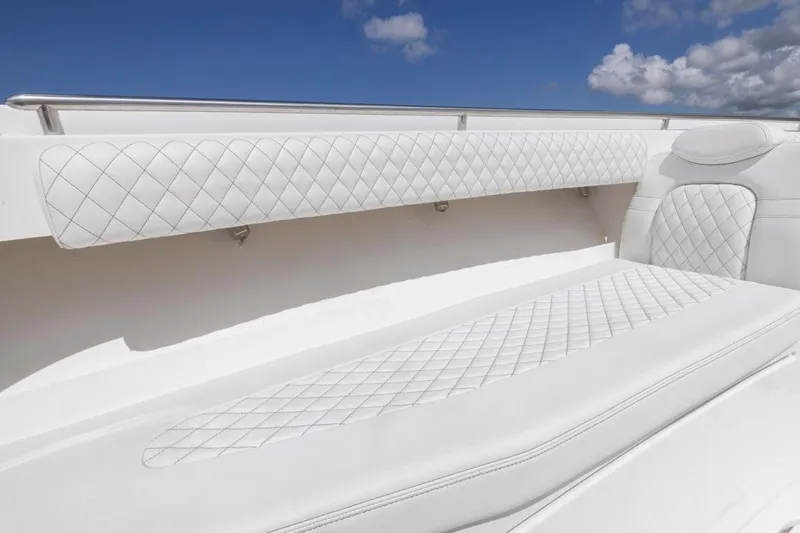 Slide: The Image of Luxurious white seating on 2023 HCB 39 Speciale boat under blue sky. - 14