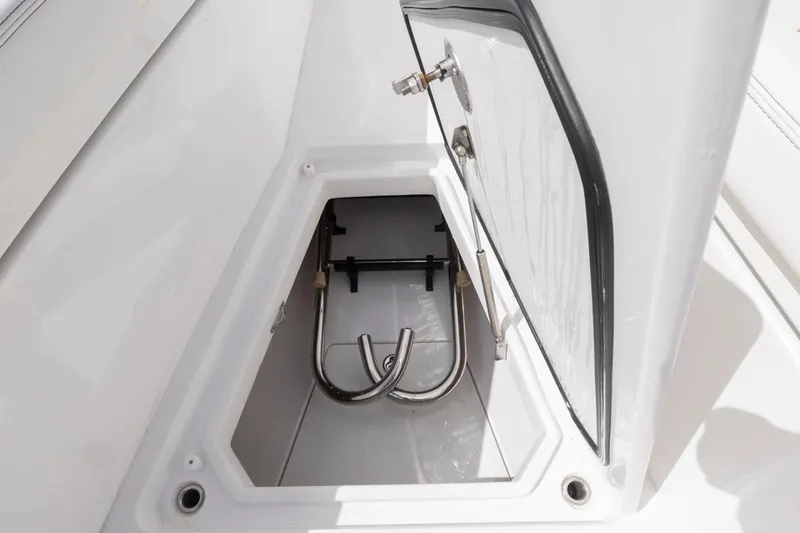 Slide: The Image of Open storage compartment on 2023 HCB 39 Speciale boat, featuring stainless steel hardware. - 16