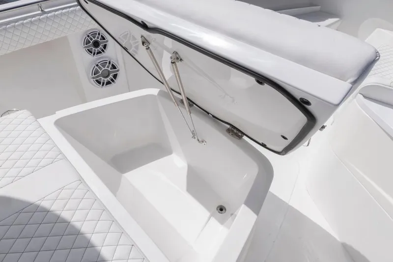 Slide: The Image of Open storage compartment on 2023 HCB 39 Speciale boat with quilted seating. - 17