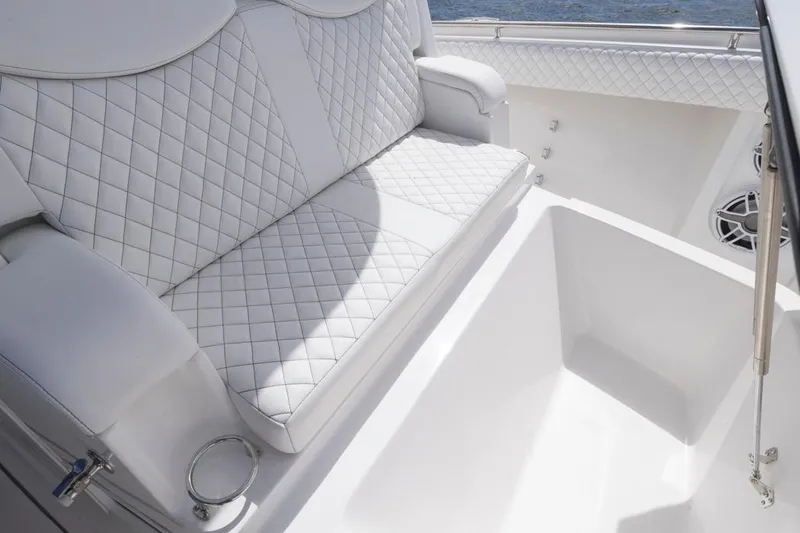 Slide: The Image of Luxurious white seating on 2023 HCB 39 Speciale boat, featuring diamond stitching. - 18