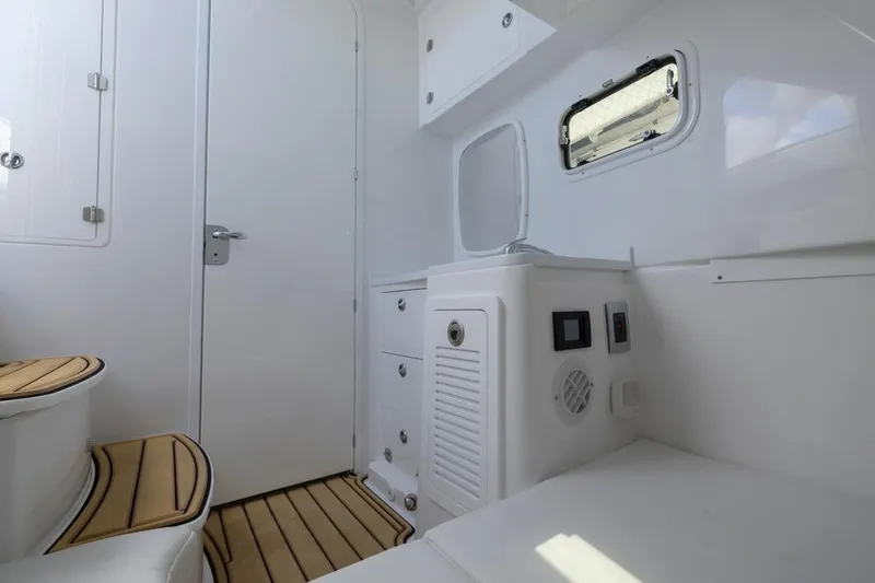 Slide: The Image of Interior of 2023 HCB 39 Speciale boat with white cabinetry and wood accents. - 25