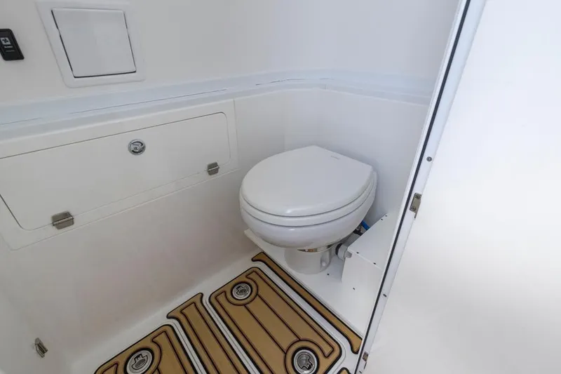 Slide: The Image of 2023 HCB 39 Speciale boat interior with compact marine toilet and storage compartment. - 27