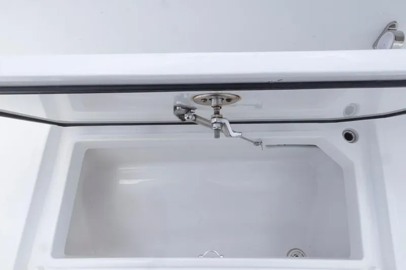 Slide: The Image of Open storage compartment in 2023 HCB 39 Speciale boat, featuring a sleek white interior. - 28