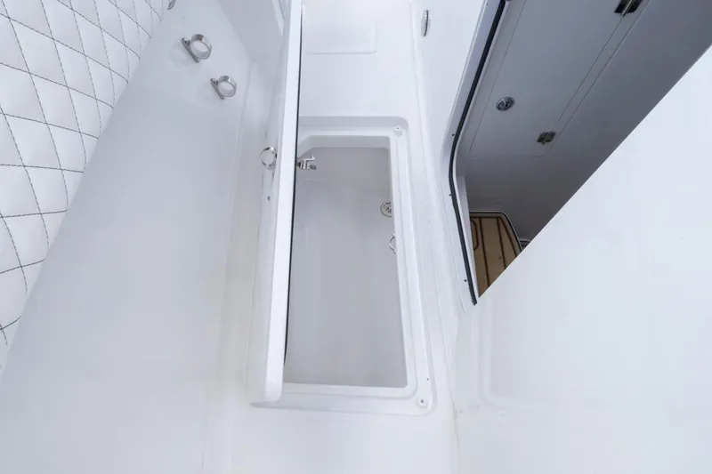 Slide: The Image of Interior view of 2023 HCB 39 Speciale boat, featuring sleek white design and storage compartment. - 29