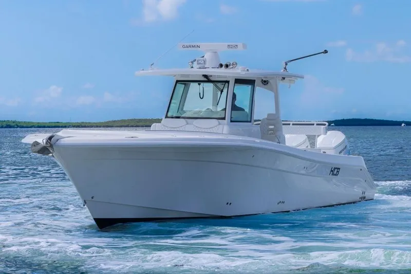 Slide: The Image of 2023 HCB 39 Speciale boat cruising on clear blue water. - 3