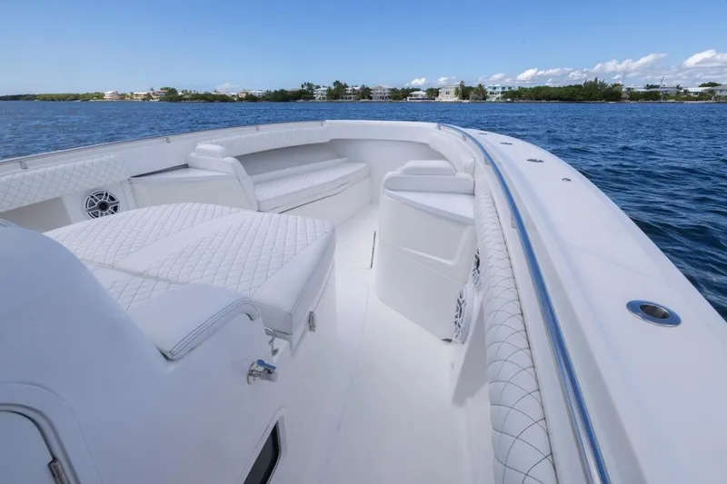 Slide: The Image of 2023 HCB 39 Speciale luxury boat interior with white seating on calm water. - 30