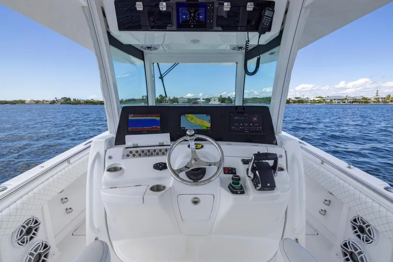 Slide: The Image of Helm of 2023 HCB 39 Speciale boat with navigation screens and controls on open water. - 36