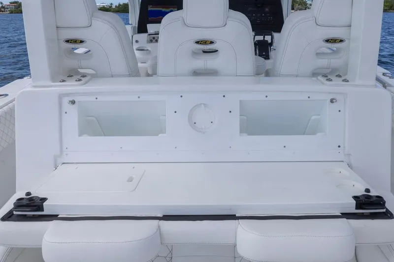 Slide: The Image of 2023 HCB 39 Speciale boat interior with white seating and dashboard. - 39