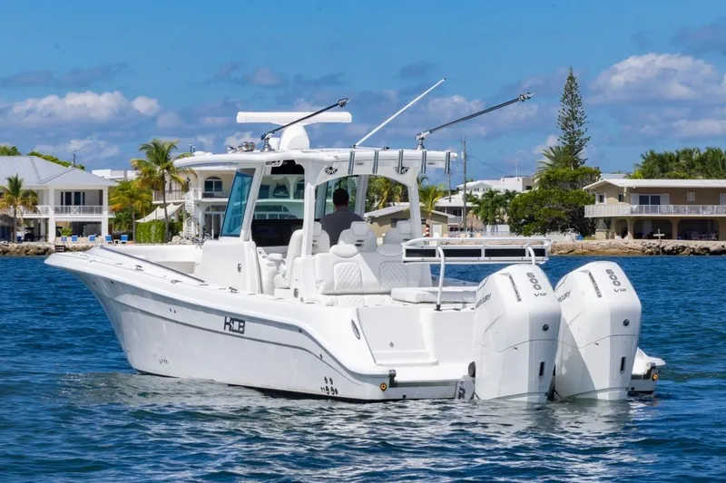 Slide: The Image of 2023 HCB 39 Speciale boat with dual engines on a sunny waterfront. - 4