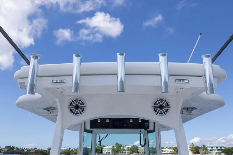 Slide: The Image of 2023 HCB 39 Speciale boat with rod holders and speakers against blue sky. - 43