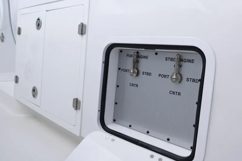 Slide: The Image of Control panel on 2023 HCB 39 Speciale boat, featuring labeled engine switches. - 47