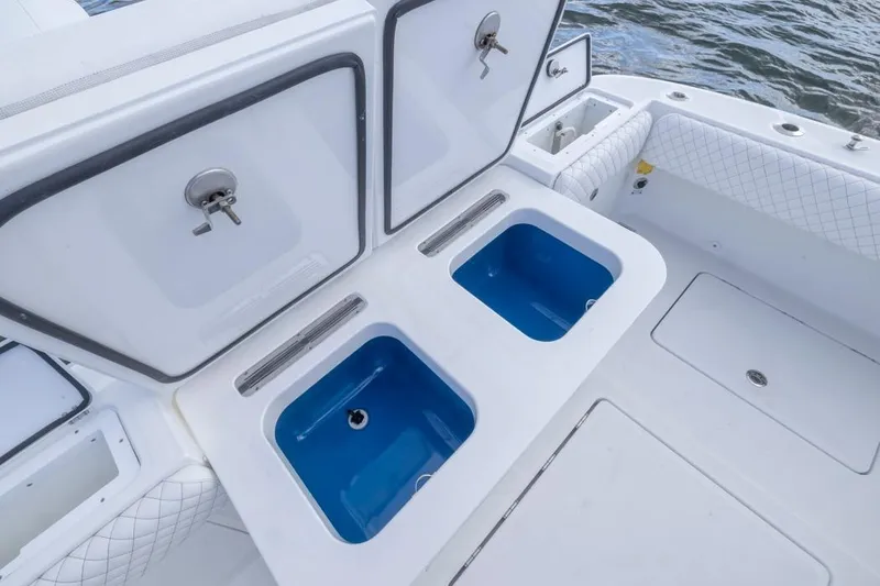 Slide: The Image of 2023 HCB 39 Speciale boat with open storage compartments and blue interior. - 53