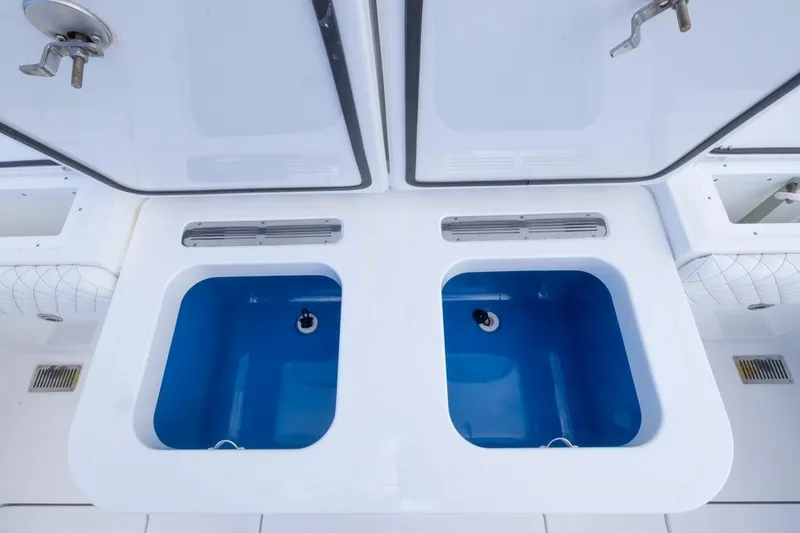 Slide: The Image of 2023 HCB 39 Speciale boat with dual blue livewells and storage compartments. - 54