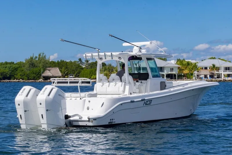 Slide: The Image of 2023 HCB 39 Speciale boat cruising on a sunny day near waterfront homes. - 6