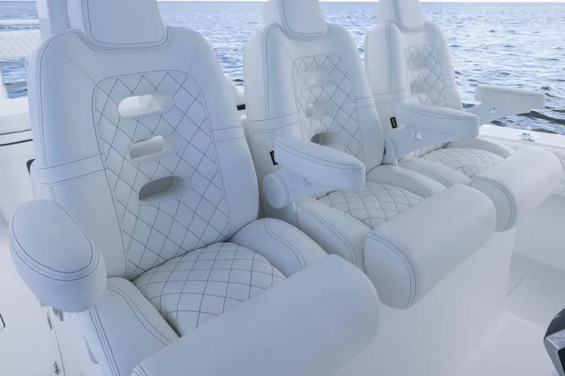 Slide: The Image of Luxurious white seating on 2023 HCB 39 Speciale boat, featuring diamond stitching. - 63