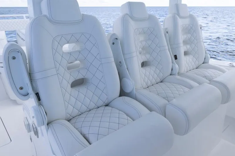 Slide: The Image of Luxurious white seating on 2023 HCB 39 Speciale boat, featuring diamond stitching. - 64