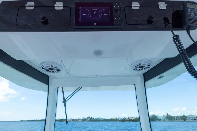 Slide: The Image of 2023 HCB 39 Speciale boat dashboard with navigation controls and ocean view. - 65