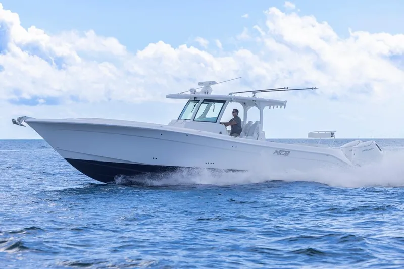Slide: The Image of 2023 HCB 39 Speciale boat cruising on open water under a clear sky. - 66