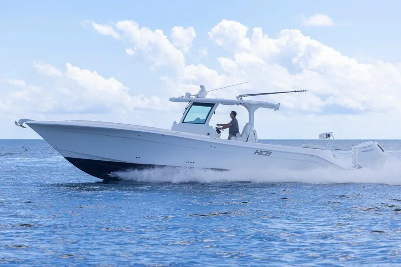 Slide: The Image of 2023 HCB 39 Speciale boat cruising on open water under a clear sky. - 67