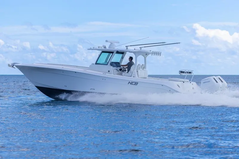 Slide: The Image of 2023 HCB 39 Speciale boat cruising on open water under a clear blue sky. - 68