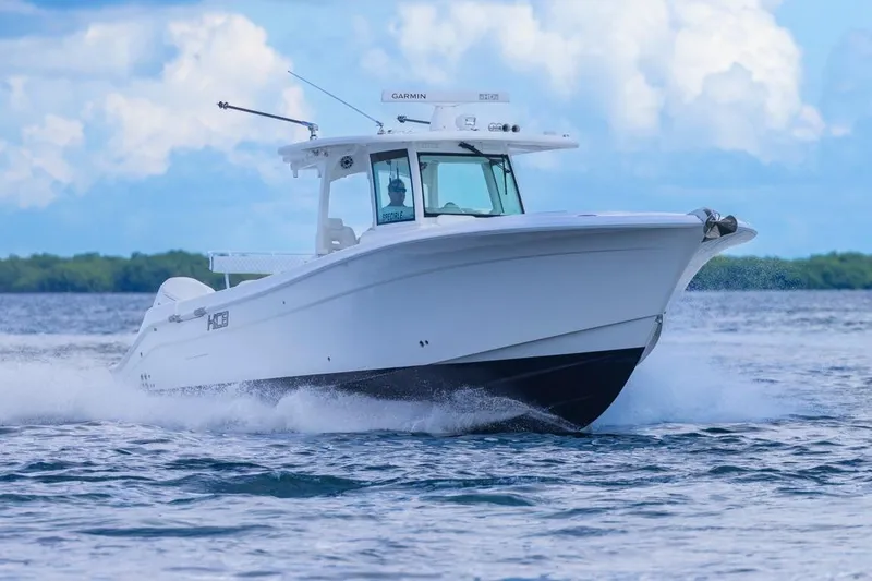 Slide: The Image of 2023 HCB 39 Speciale boat cruising on open water under a blue sky. - 70