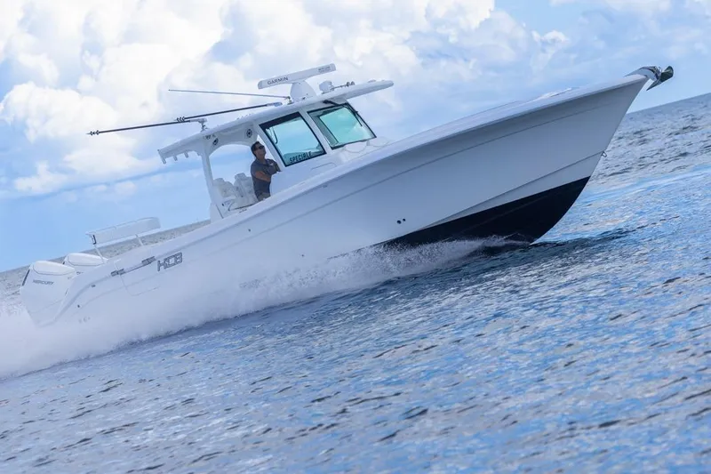 Slide: The Image of 2023 HCB 39 Speciale boat cruising on open water under a cloudy sky. - 72