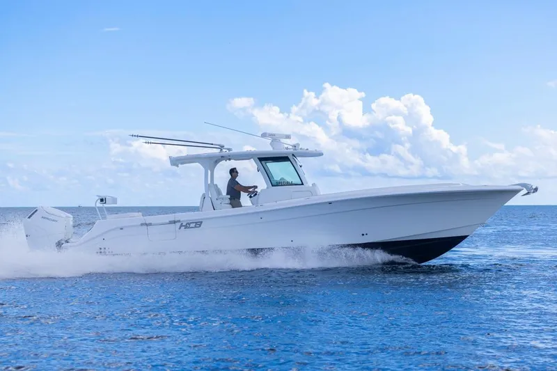 Slide: The Image of 2023 HCB 39 Speciale boat cruising on open water under a clear blue sky. - 73