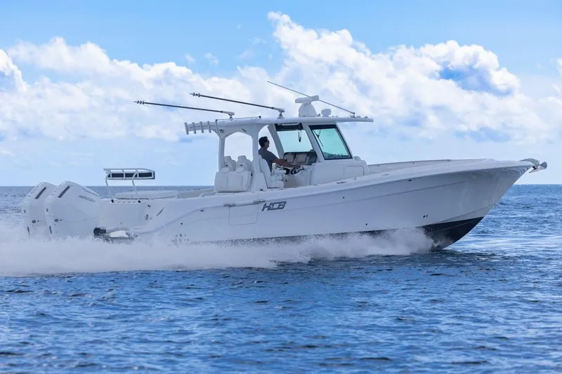 Slide: The Image of 2023 HCB 39 Speciale boat cruising on open water under a clear blue sky. - 74