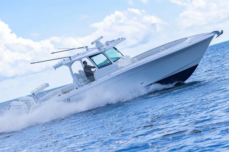 Slide: The Image of 2023 HCB 39 Speciale boat cruising on open water under a clear sky. - 75