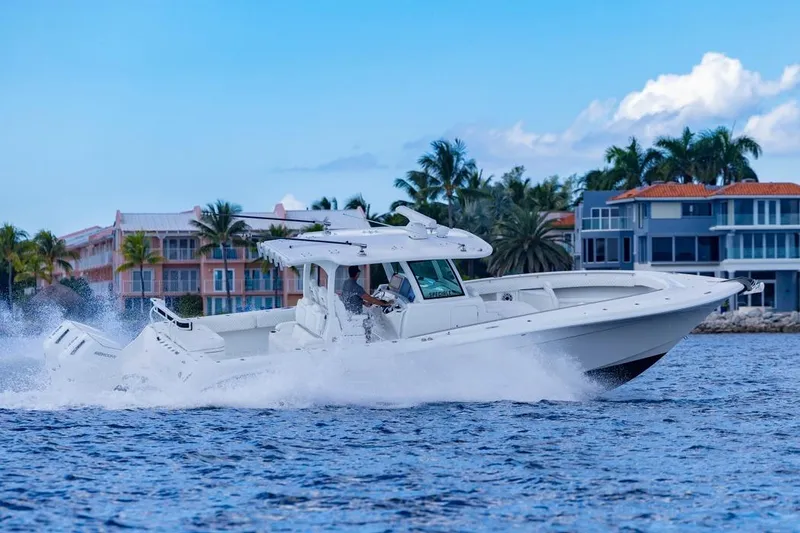 Slide: The Image of 2023 HCB 39 Speciale boat cruising on water near luxury waterfront homes. - 77