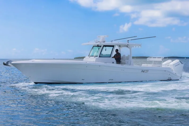 Slide: The Image of 2023 HCB 39 Speciale boat cruising on open water under a clear blue sky. - 8