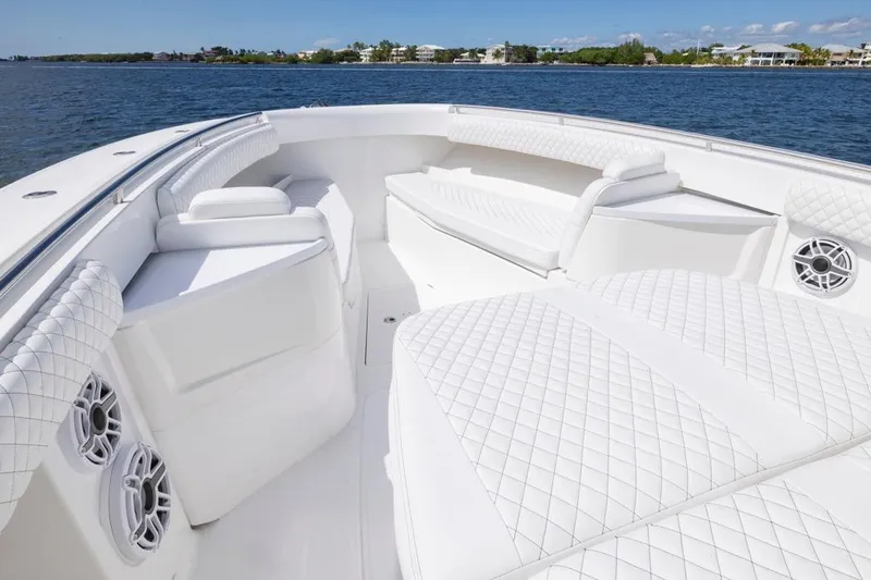 Slide: The Image of Luxurious 2023 HCB 39 Speciale boat interior with white quilted seating on open water. - 9