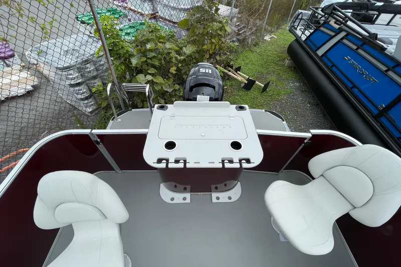 Slide: The Image of 2026 Starcraft EX 20 FD boat interior with motor and seating area. - 11