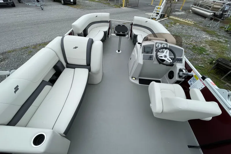 Slide: The Image of 2026 Starcraft EX 20 FD boat interior with seating and motor, parked outdoors. - 12