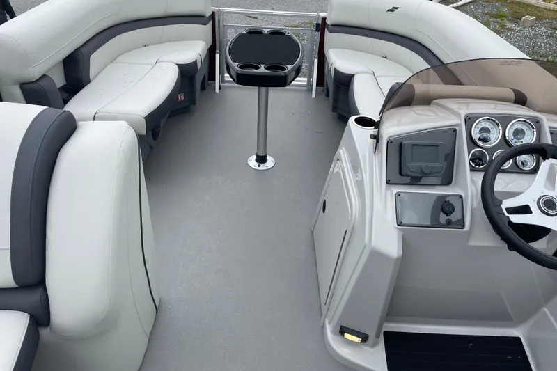 Slide: The Image of 2026 Starcraft EX 20 FD boat dashboard with steering wheel and control panel. - 4