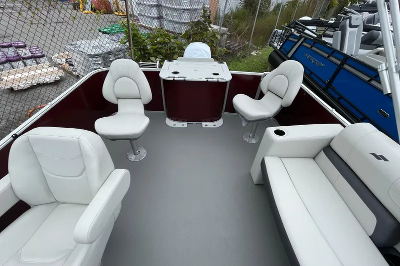 Slide: The Image of 2026 Starcraft EX 20 FD boat interior with white seats and table, outdoor setting. - 6