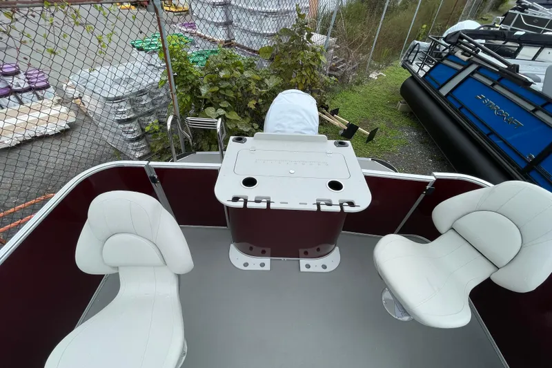 Slide: The Image of 2026 Starcraft EX 20 FD boat interior with white seating and gray flooring. - 7