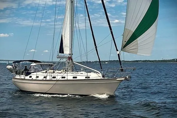 The Image of 2002 Island Packet 420 sailboat cruising on open water under clear skies. - 0