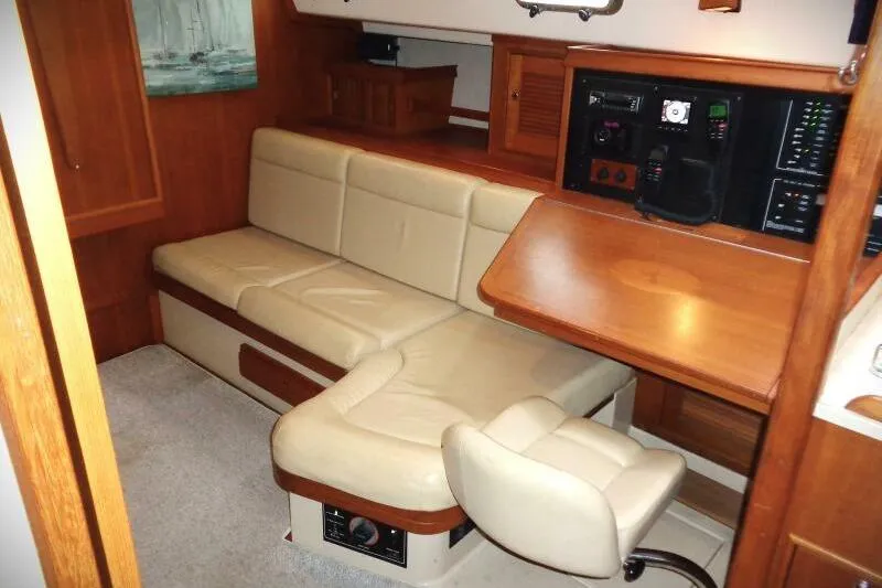 Slide: The Image of Interior of 2002 Island Packet 420 yacht with beige seating and navigation station. - 10