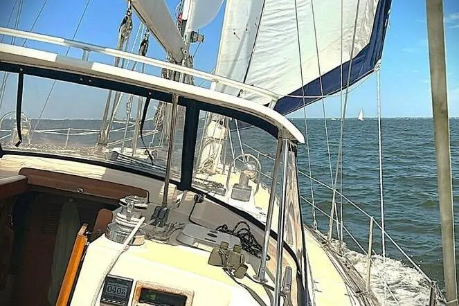Slide: The Image of Cockpit of 2002 Island Packet 420 sailboat with polished wood and nautical equipment. - 12